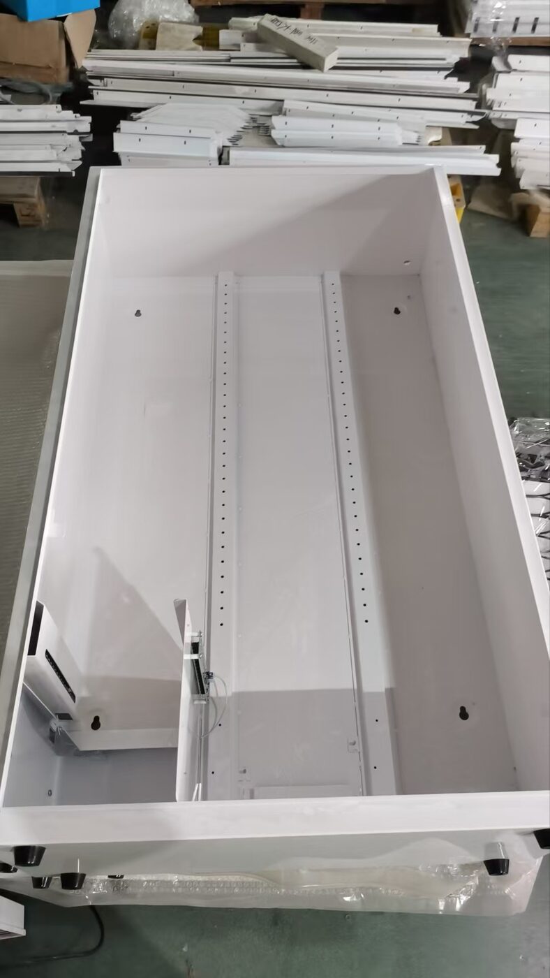 Bare powder-coated cabinet of the wall-mount vending machine showing the central mounting rail and shelf hole pattern