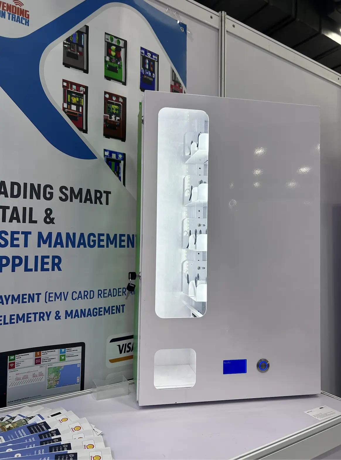 Screen-free wall-mount vending machine with illuminated product display and collection bin
